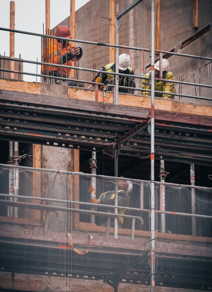 Services Construction workers engage in building tasks on a scaffold in Hamburg.