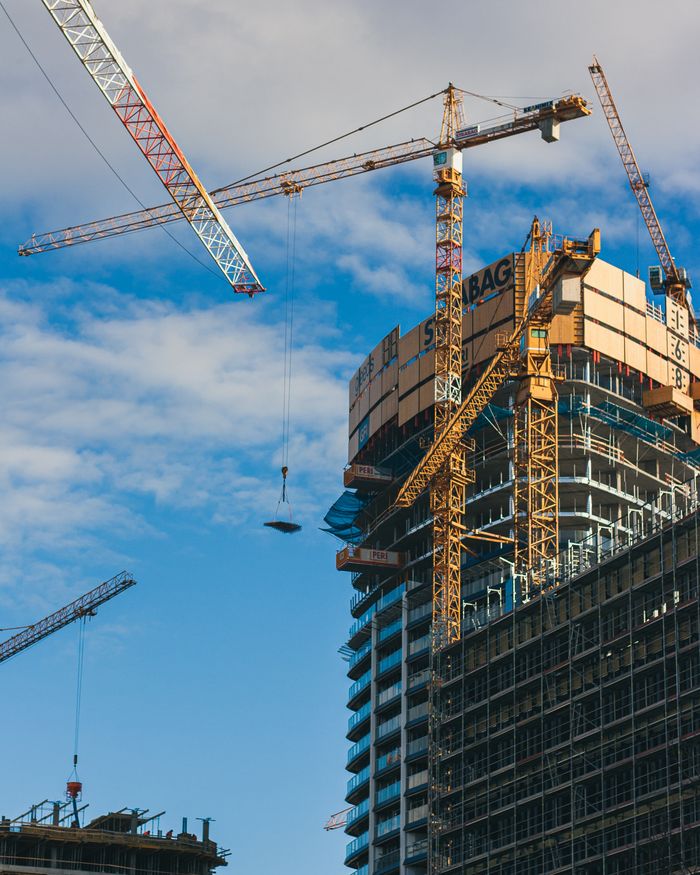 Crafting Captivating Headlines: Your awesome post title goes here High-rise building construction with cranes in Bratislava, Slovakia under a clear blue sky.