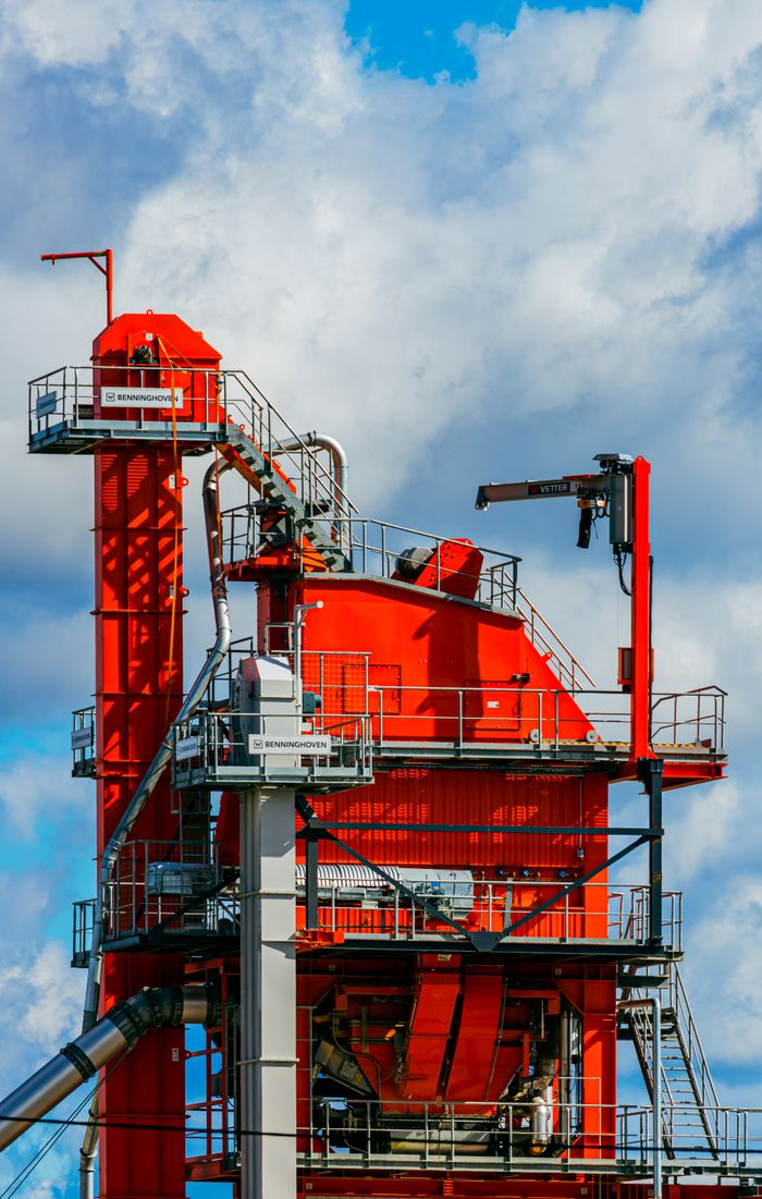 The Art of Drawing Readers In: Your attractive post title goes here Vivid red asphalt mixing plant tower against a bright blue sky in Tartu, Estonia.